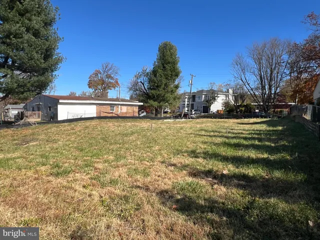 a backyard of a house with plants and trees