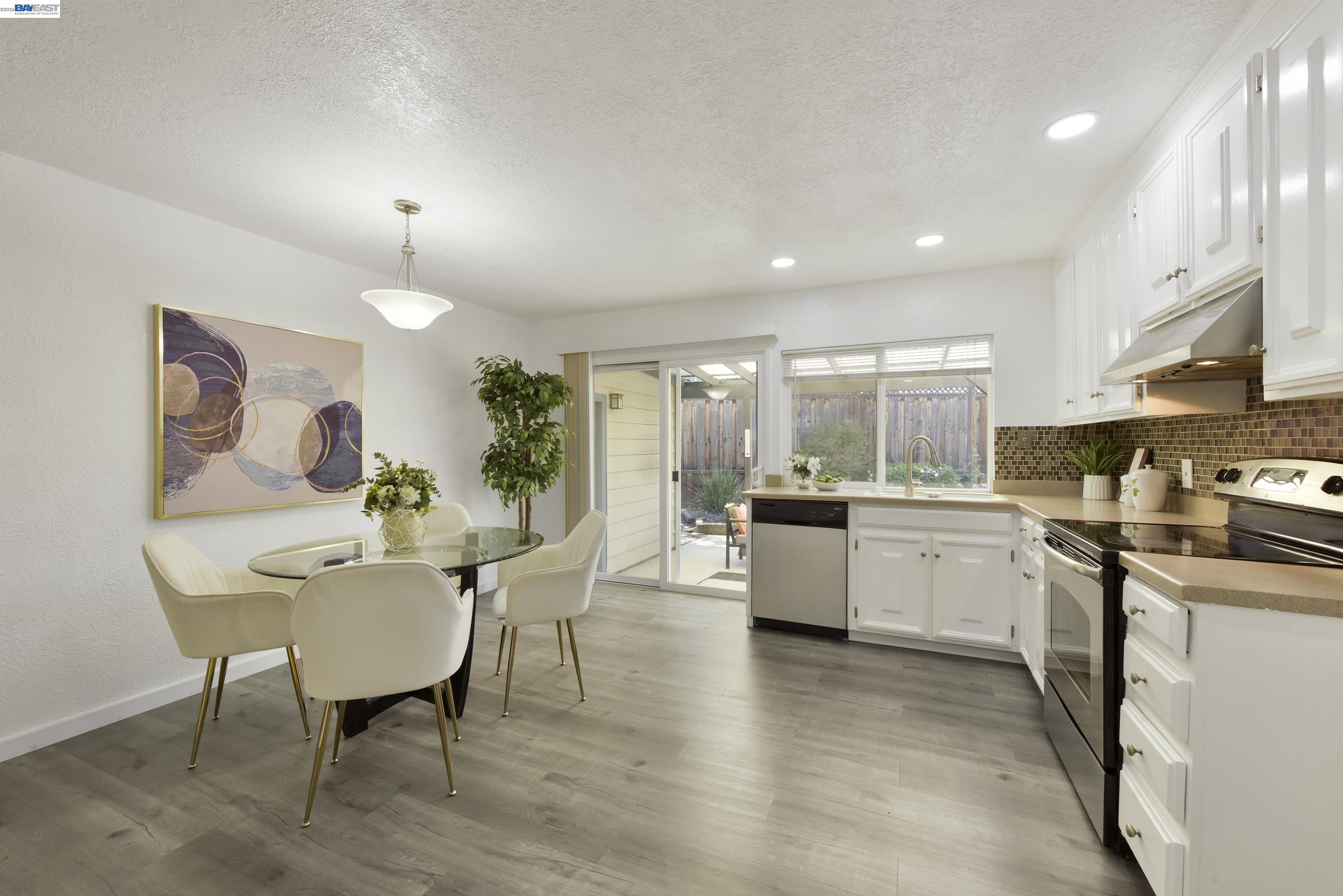 a kitchen with sink cabinets and dining table
