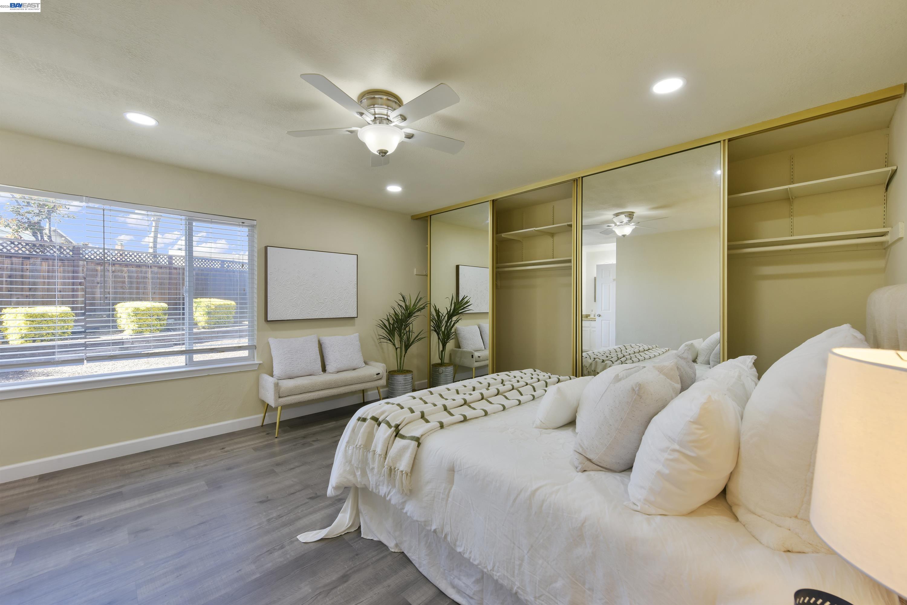20 Yale Court San Ramon, CA 94583 - Photo 16 of 27 a bedroom with a large bed and a chandelier