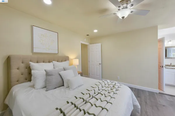 a bedroom with a large bed and a chandelier