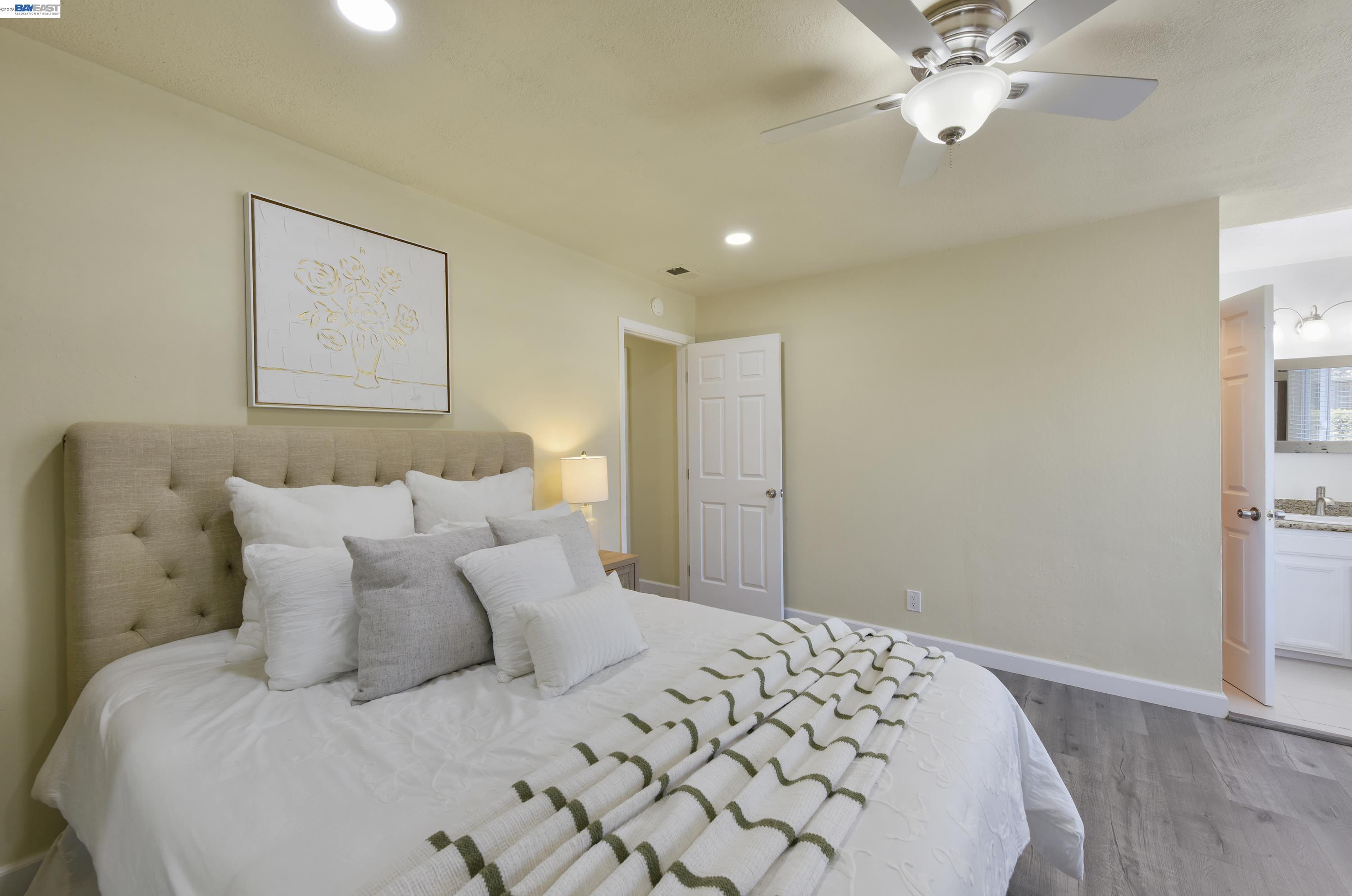 20 Yale Court San Ramon, CA 94583 - Photo 17 of 27 a bedroom with a large bed and a chandelier