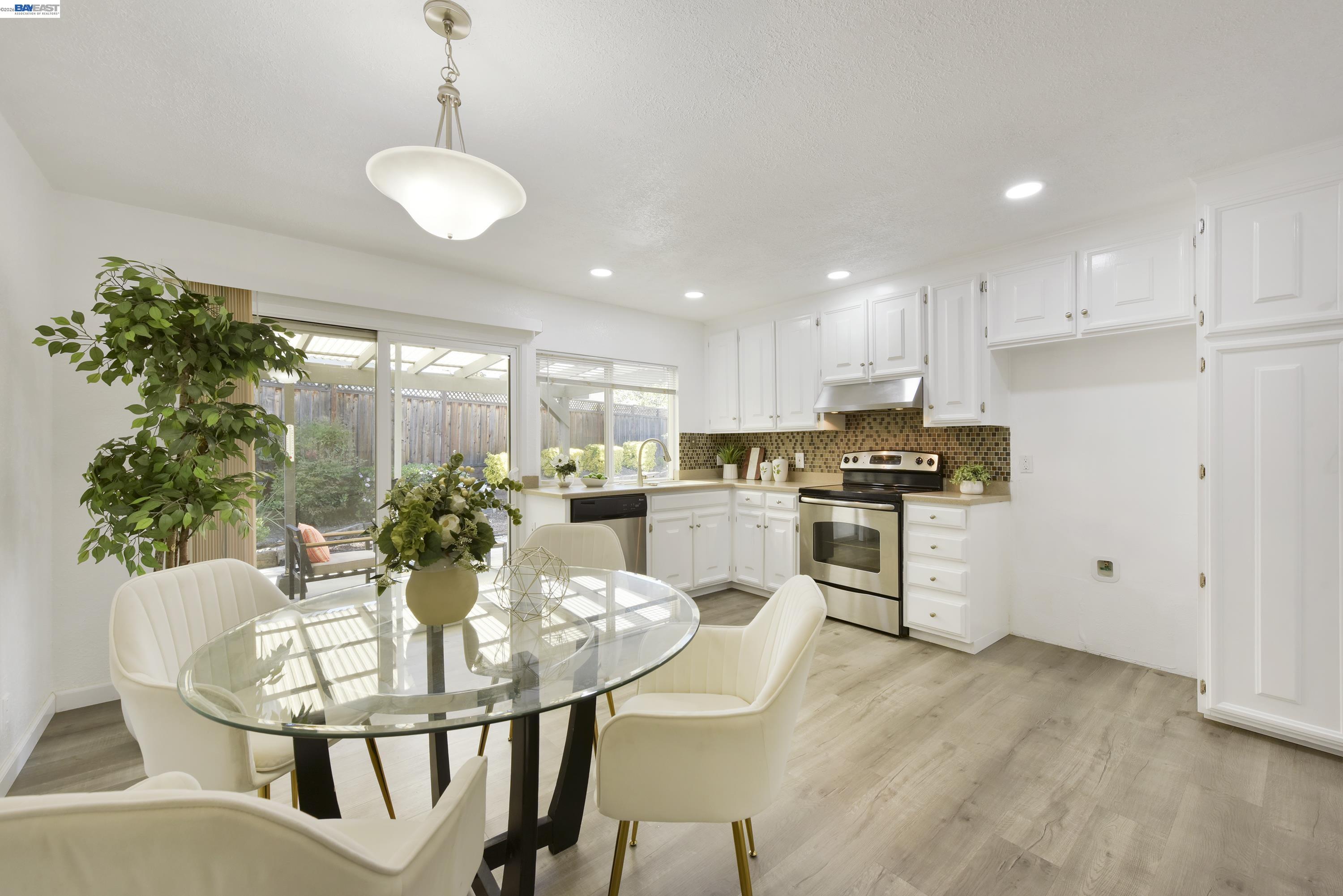 20 Yale Court San Ramon, CA 94583 - Photo 2 of 27 a kitchen with white cabinets stainless steel appliances and dining table