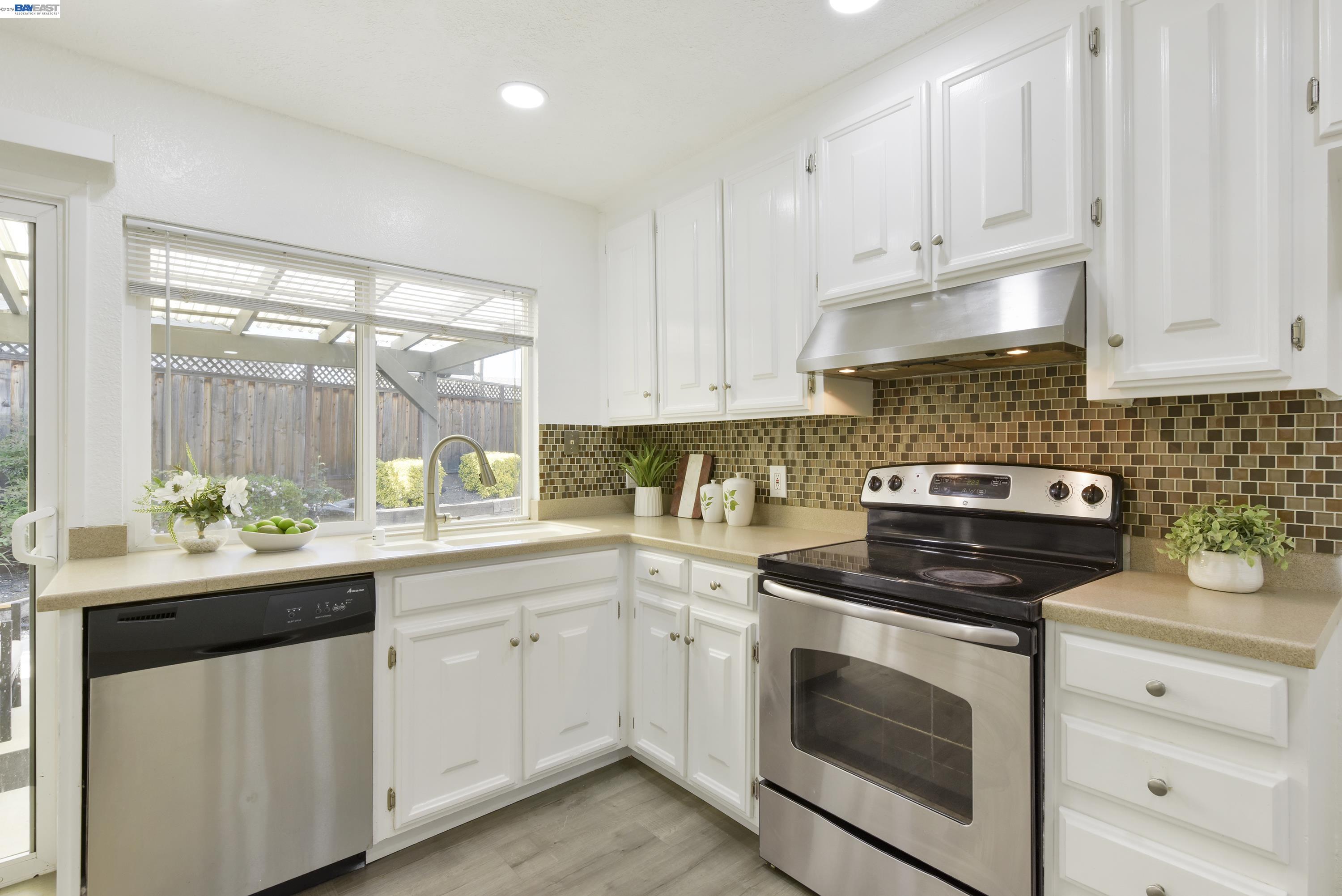 20 Yale Court San Ramon, CA 94583 - Photo 7 of 27 a kitchen with white cabinets and white appliances