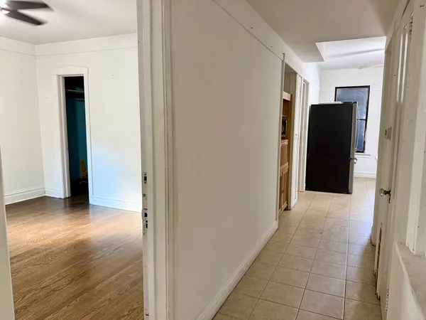 a view of hallway with wooden floor