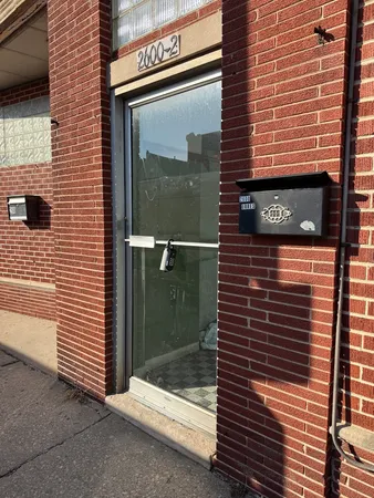 a view of a door of a brick building