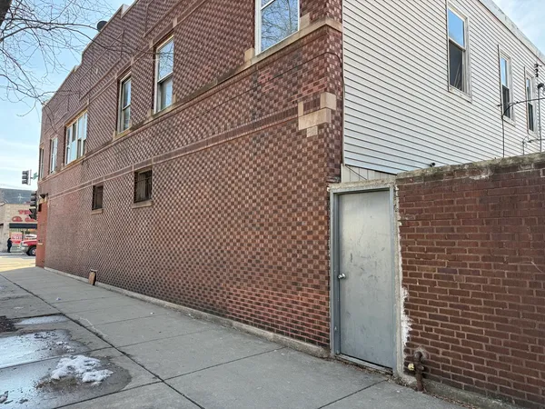 a view of a brick house with wooden walls