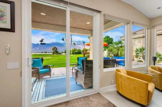 a kitchen with stainless steel appliances kitchen island granite countertop a table chairs sink and cabinets