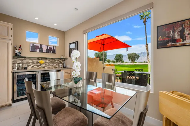 a kitchen with stainless steel appliances white cabinets and wooden floor
