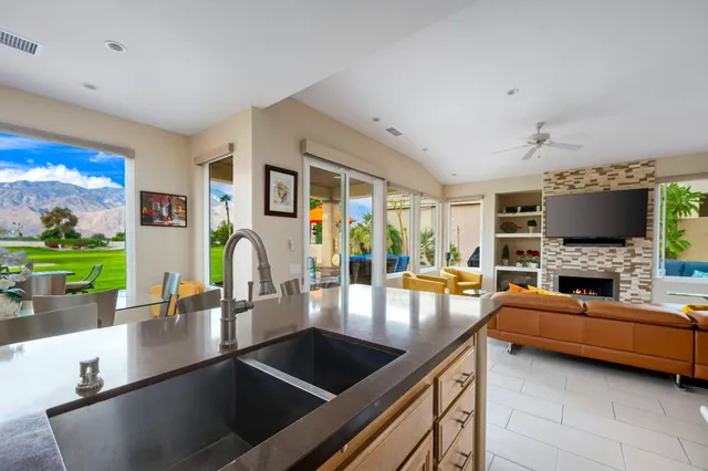a dining room with furniture and a floor to ceiling window