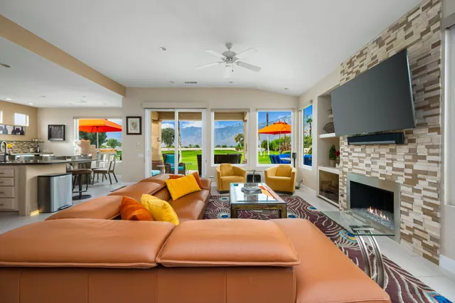 a living room with fireplace furniture and a flat screen tv