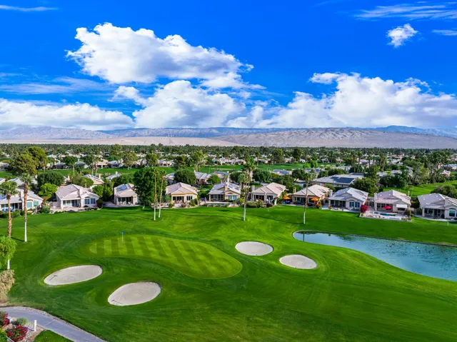 an aerial view of a house with garden space and street view