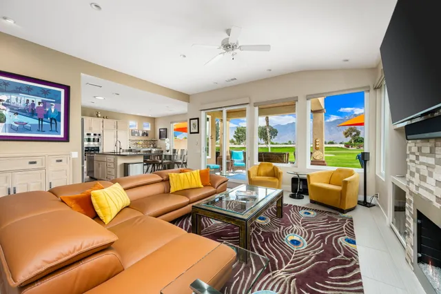 a living room with furniture fireplace and flat screen tv
