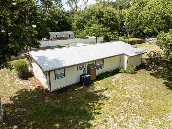 a view of a house with a yard and furniture