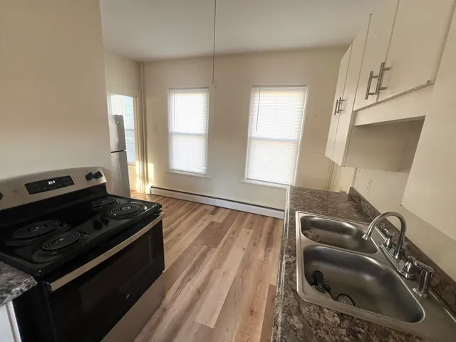 a kitchen that has a sink and a stove
