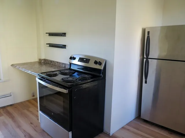 a stove top oven sitting inside of a kitchen