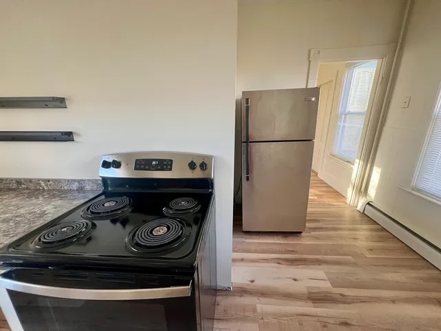 a stove top oven sitting inside of a kitchen