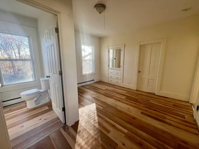 a view of a room with wooden floor and windows