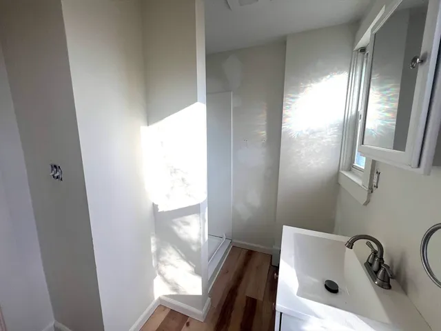 a bathroom with a sink a mirror and a bathtub