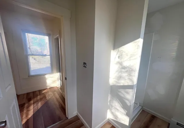 a view of hallway with furniture and a window
