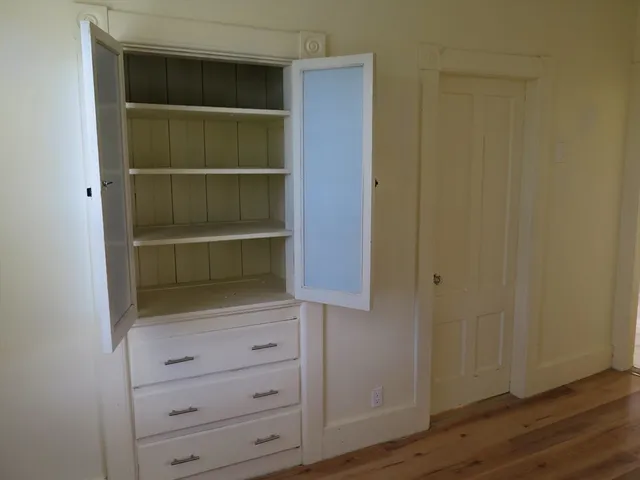 a view of walk in closet with empty racks
