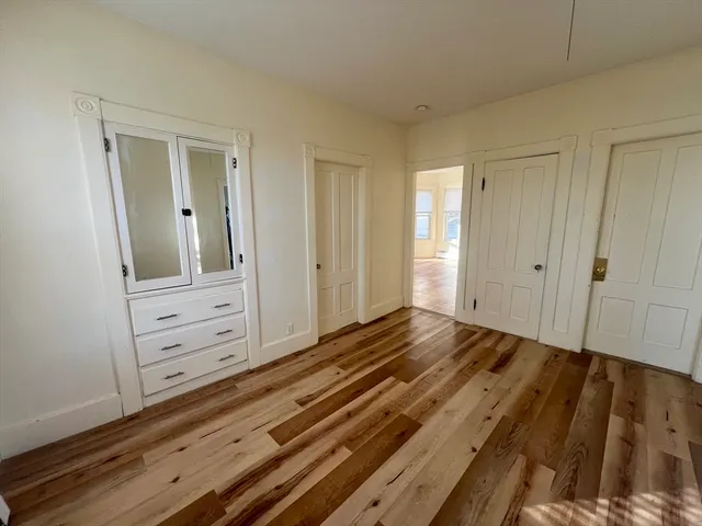 a view of an empty room and wooden floor