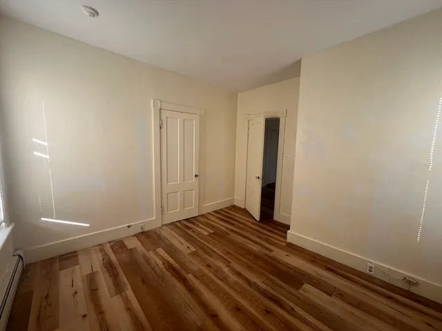 a view of a room with wooden floor
