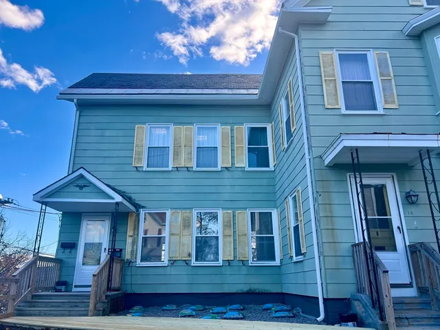 a view of brick house with large windows