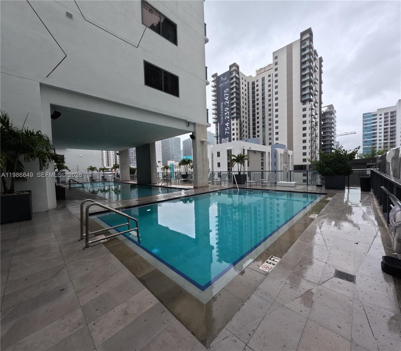 a swimming pool with outdoor seating and city view