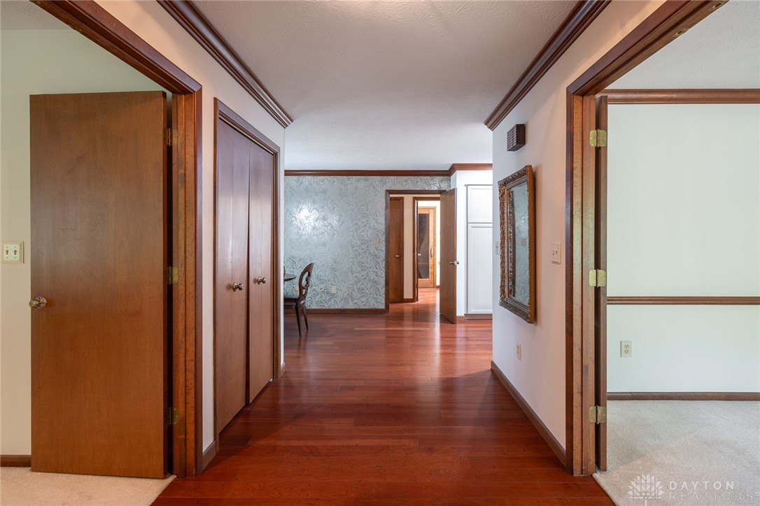 273 North Alpha Bellbrook Road Dayton, OH 45434 - Photo 12 of 43 This spacious hallway features rich hardwood flooring and leads to various rooms within the home.