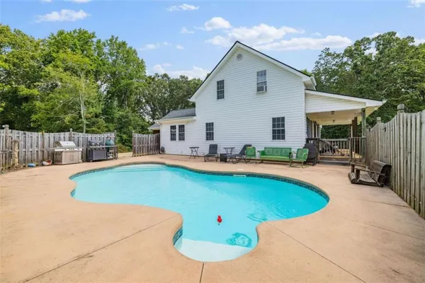 a view of a patio with swimming pool and porch