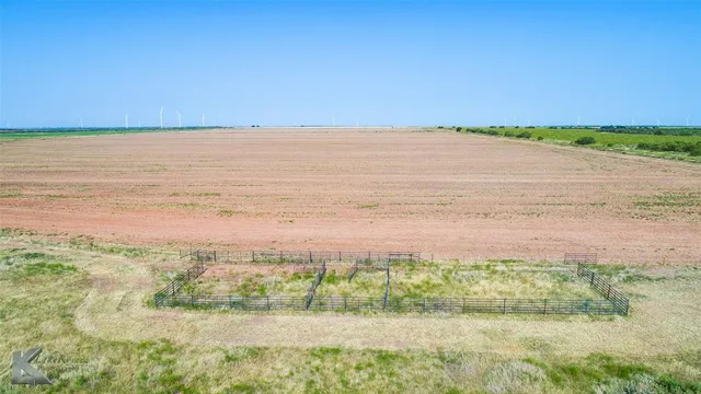 a view of a field with an ocean view