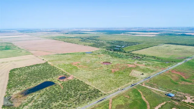 a view of a field with an ocean