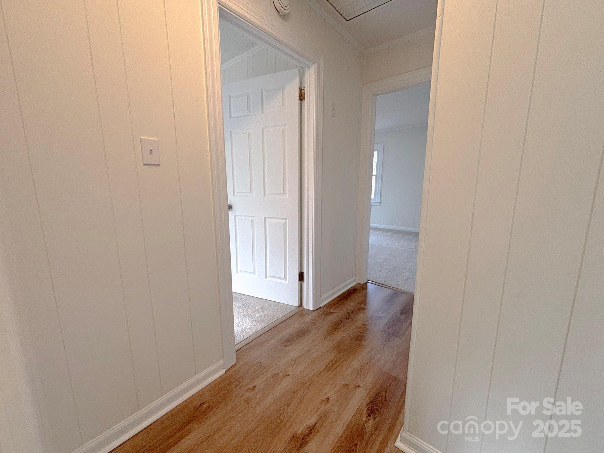 1117 Red Street Kannapolis, NC 28081 - Photo 16 of 48 a view of an empty room with wooden floor and a bathroom
