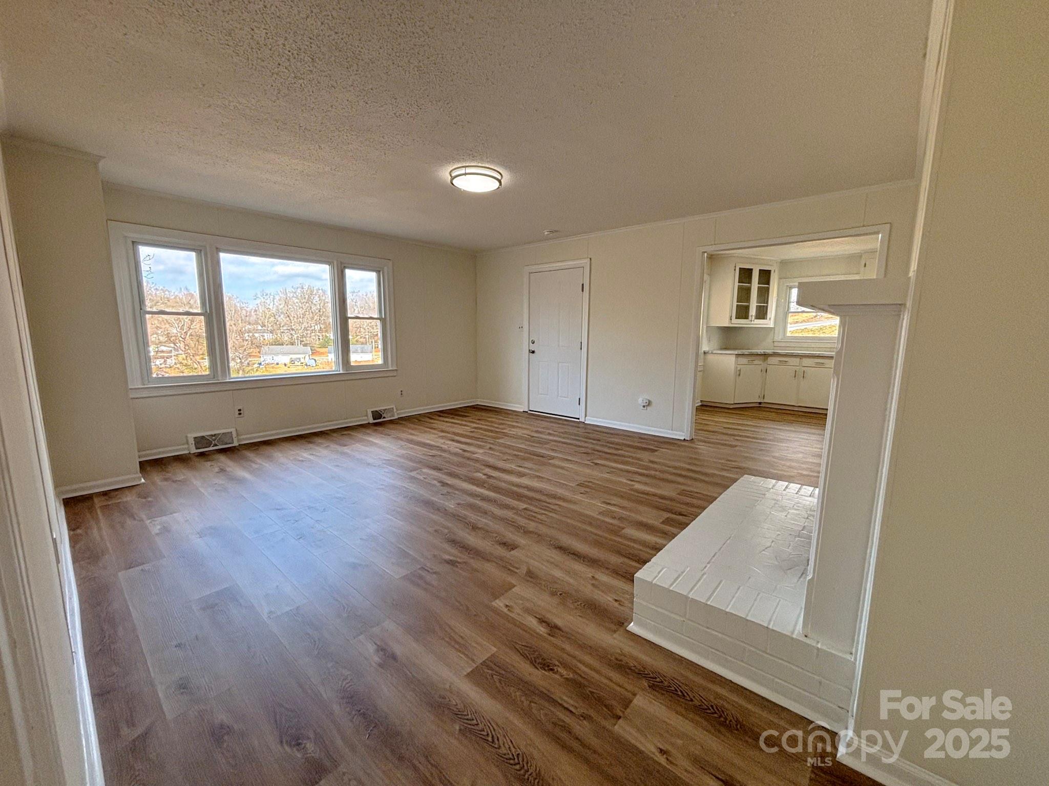 1117 Red Street Kannapolis, NC 28081 - Photo 22 of 48 wooden floor in an empty room with a window