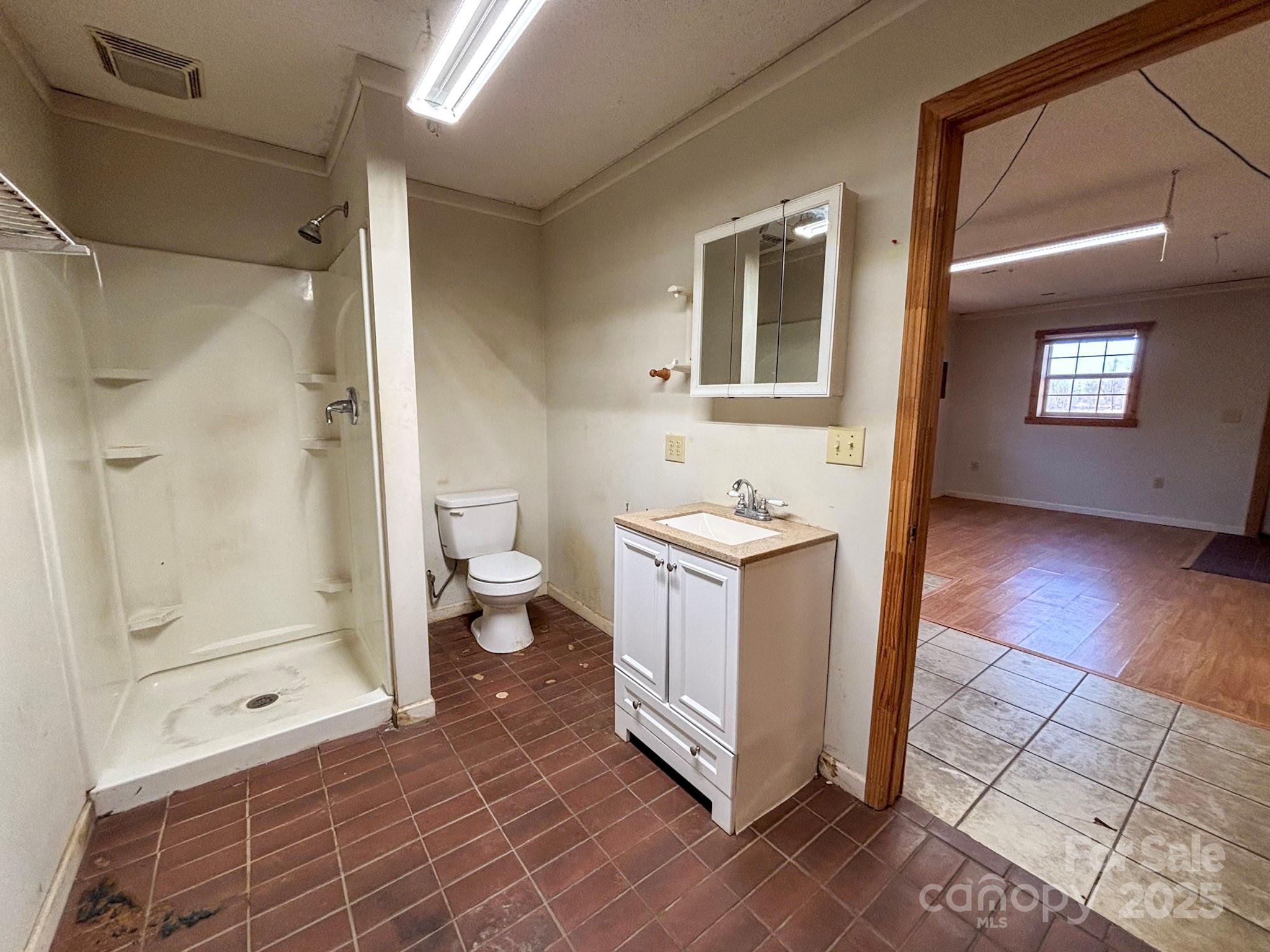 1117 Red Street Kannapolis, NC 28081 - Photo 38 of 48 a spacious bathroom with a glass door shower a toilet and a sink