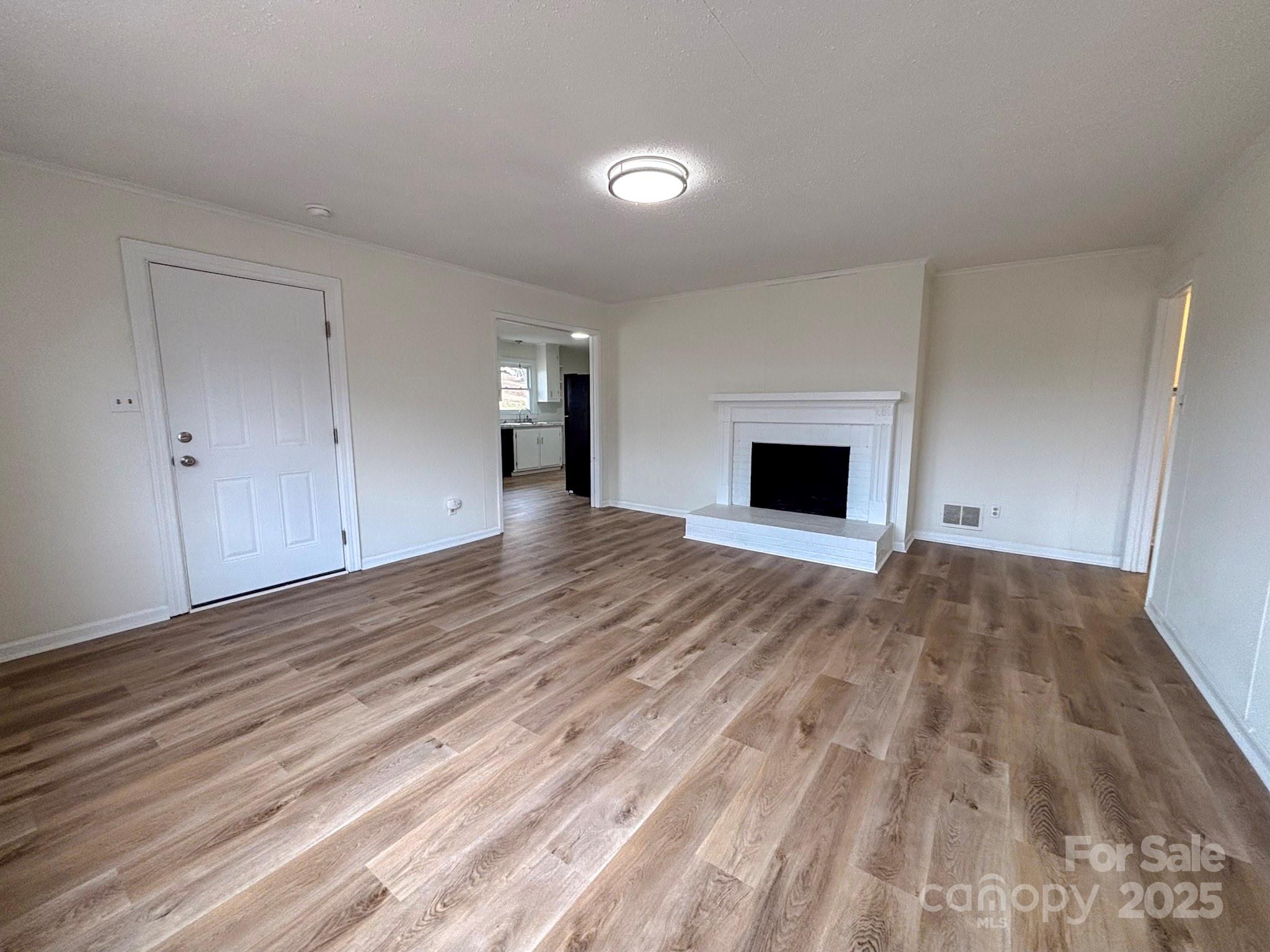 1117 Red Street Kannapolis, NC 28081 - Photo 4 of 48 a view of an empty room with wooden floor and a window