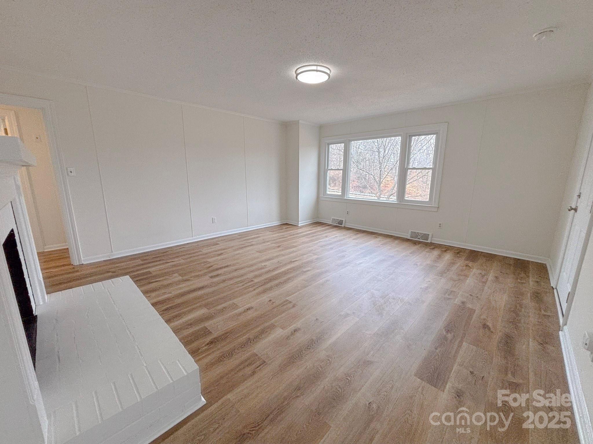 1117 Red Street Kannapolis, NC 28081 - Photo 5 of 48 an empty room with wooden floor and windows