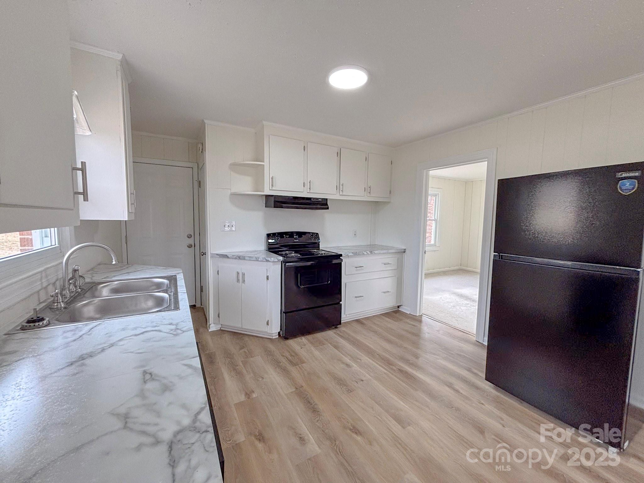 1117 Red Street Kannapolis, NC 28081 - Photo 9 of 48 a kitchen with granite countertop a refrigerator and a sink