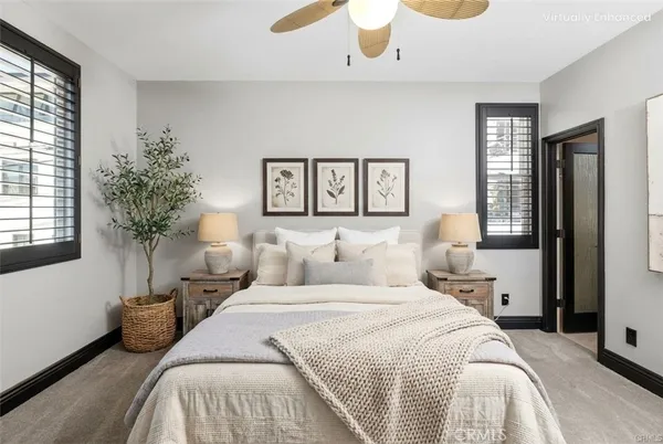 a bedroom with a large bed and a potted plant