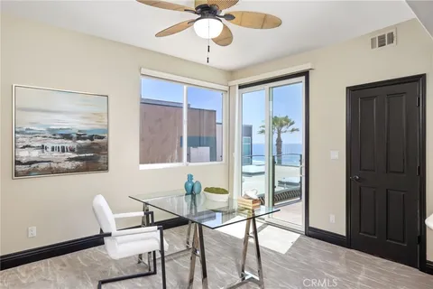 a view of a dining room with furniture and a chandelier fan