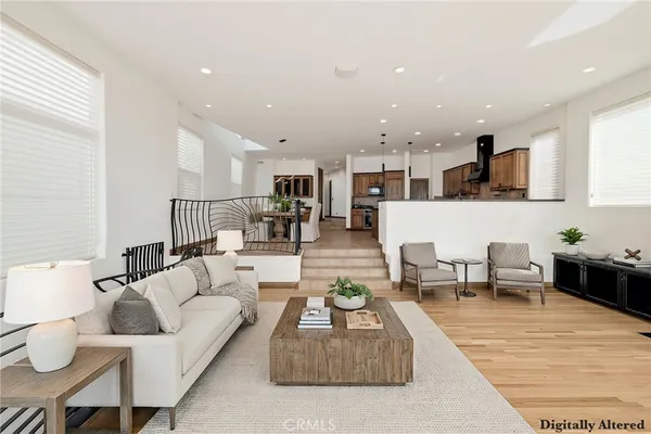a living room with furniture and view of kitchen