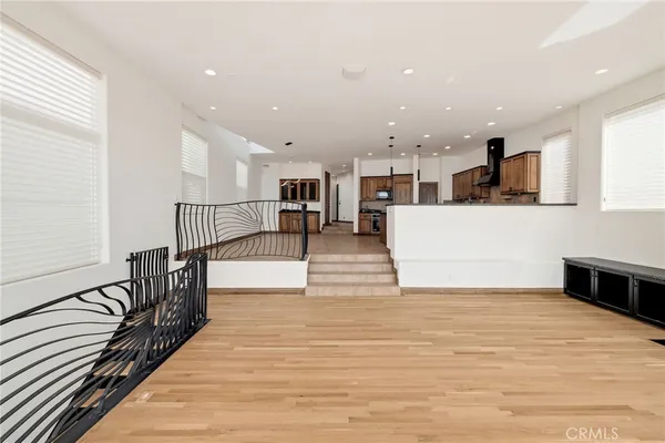 a view of a kitchen with wooden floor and a sink
