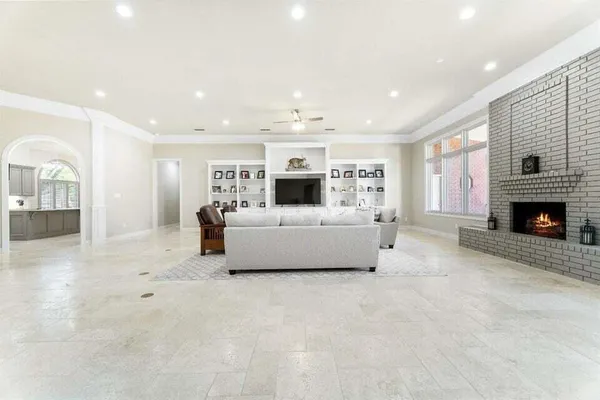 a spacious bedroom with a bed and a fireplace