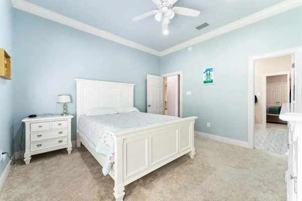 a bedroom with a bed and a chandelier