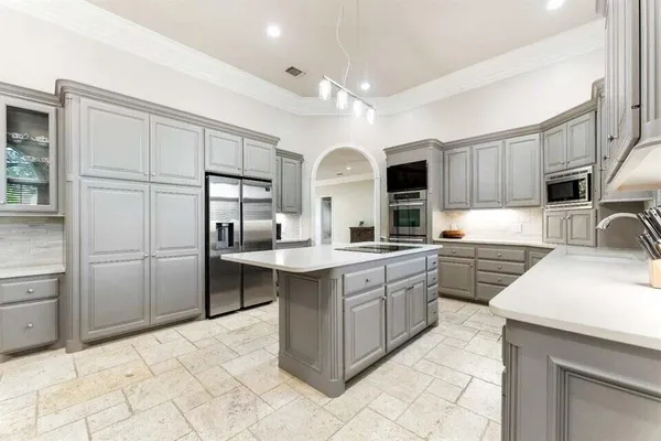 a kitchen with granite countertop a sink stainless steel appliances and cabinets