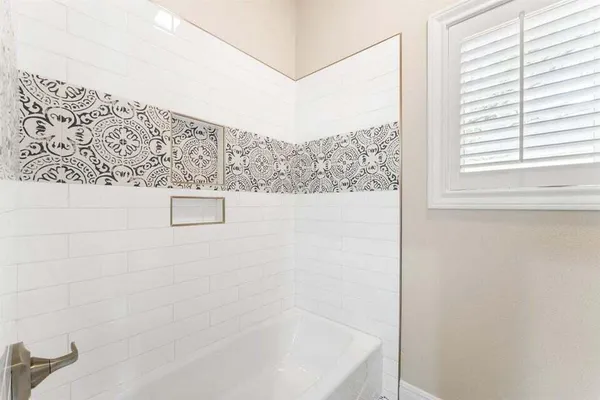 a bathroom with double vanity sink and a mirror
