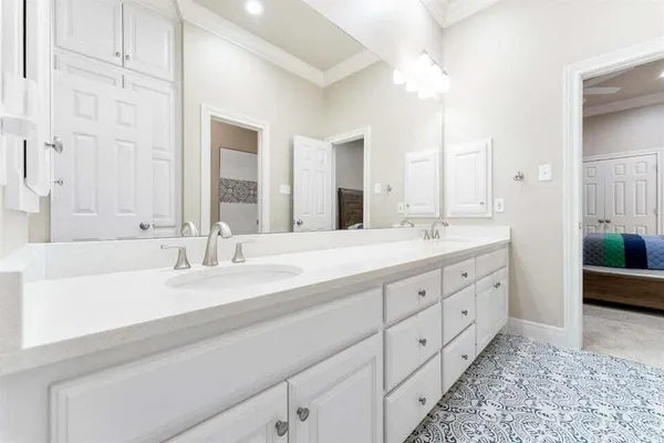 a bathroom with double vanity sink and a mirror