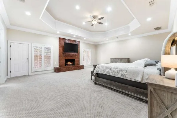 a spacious bedroom with a bed and ceiling fan