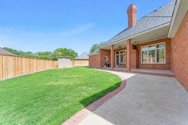a view of a house with backyard and porch