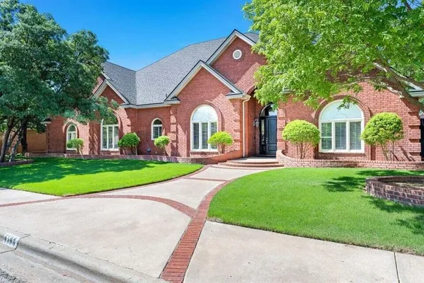 a front view of a house with a yard table and chairs
